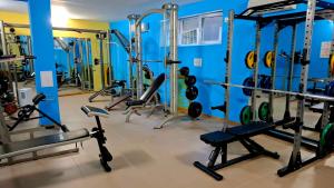 a gym with a blue wall and lots of machines at Peaceful Retreat at Sunset Resort Complex, Kosharitsa in Kosharitsa