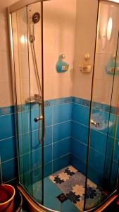 a bathroom with a shower with blue tiles at Peaceful Retreat at Sunset Resort Complex, Kosharitsa in Kosharitsa +14 photos