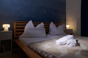 a bed with white pillows and towels on it at Zirbitzblick in Mönchegg