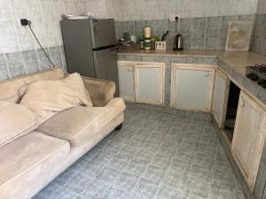 a living room with a couch in a kitchen at Turkish Muscat hostel in Muscat