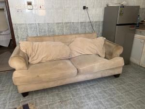 a couch with two pillows on it in a kitchen at Turkish Muscat hostel in Muscat +10 photos
