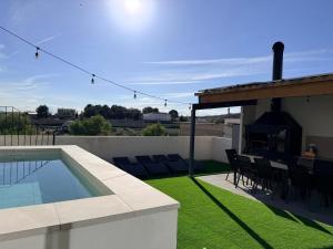 a backyard with a swimming pool and a fireplace at CASA ALKAPEPE in Ontur
