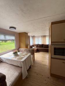 a living room with a table and a couch at The Sea Spot in Zvejniekciems
