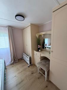 a room with a desk and a sink and a mirror at The Sea Spot in Zvejniekciems +2 photos