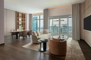 a living room with a couch and a table at The Ritz-Carlton Jakarta, Pacific Place in Jakarta +47 photos