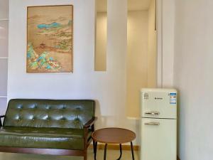 a room with a couch and a table and a refrigerator at Siquijor Jade ocean resort in Siquijor