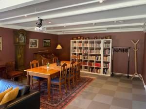 a dining room with a table and a book shelf at Austbø Hotell in Rauland +31 photos