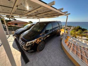 a car parked under a cover on a balcony at BM SUITES CEFALU in Cefalù
