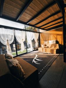 a bedroom with a bed and a large window at FREESCAPE Quiet Reset - Lakeside Mountainview in Cavinti