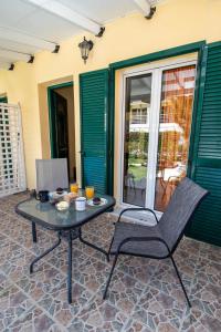 a table and a chair on a patio at Villa Ladina in Lygia