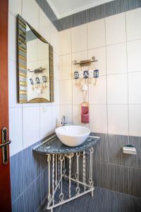 a bathroom with a sink and a mirror at Villa Ladina in Lygia +133 photos
