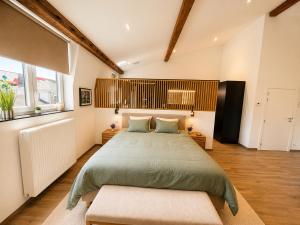 a bedroom with a large bed and two windows at Station 33 in Spa