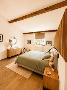 a bedroom with a large bed and a table at Station 33 in Spa +20 photos