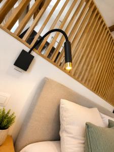 a black lamp on a wall next to a couch at Station 33 in Spa