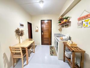 a kitchen with a wooden table and a table and chairs at Thousand Journey 2 in Naga
