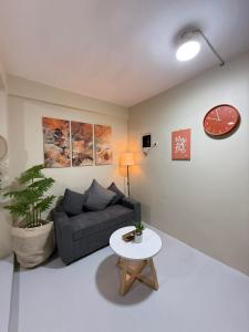 a living room with a couch and a table at Thousand Journey 2 in Naga +2 photos