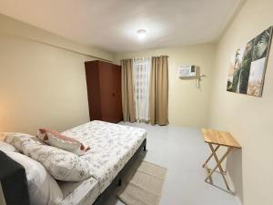a room with two beds and a table in it at Thousand Journey 2 in Naga