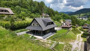 an aerial view of a house in a field at Chata Jarabina in Terchová