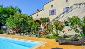 a house with a swimming pool in front of a house at Domaine de Chadeyron in Lagorce