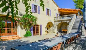 a building with a table and chairs in front of it at Domaine de Chadeyron in Lagorce