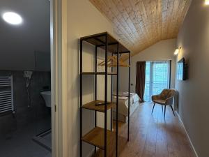 a room with a bed and a room with a shelf at Oli Home in Kazbegi +43 photos