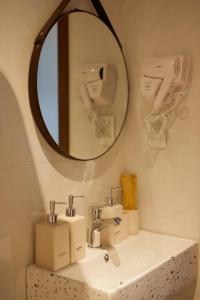 a bathroom with a sink and a mirror at Emlyhome Hanriver in Danang
