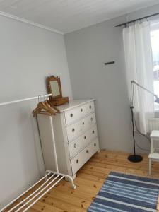 a dresser with a picture on top of it in a room at Lissmogården in Leksand