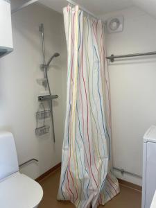 a shower curtain in a room with a white wall at Lissmogården in Leksand +6 photos
