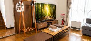 a living room with a large fish tank on a tv at A forest guesthouse with barbecue facilities in Nikko