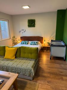 a bedroom with a bed and a couch at Apartments Veljanov - Sofra in Negotino