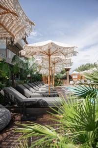 a group of chairs under a large umbrella at September15 Boutique Suites - Nikiana in Nikiana