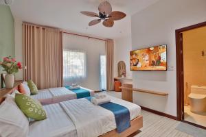 a hotel room with two beds and a bathroom at Emlyhome Hanriver in Danang