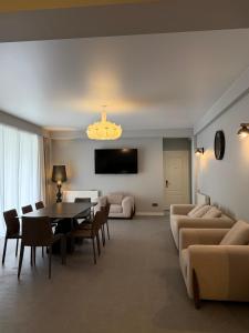 a living room with a table and a dining room at Oli Home in Kazbegi