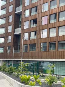 an office building with trees in front of it at Cozy Central Reykjavik in Reykjavík
