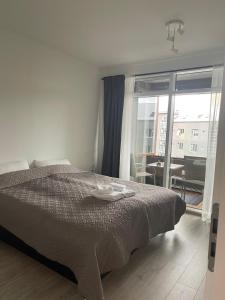 a bedroom with a bed and a view of aartment at Cozy Central Reykjavik in Reykjavík