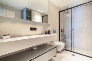 a bathroom with a shower and a sink and a toilet at Villa Incanto in Nydri +35 photos