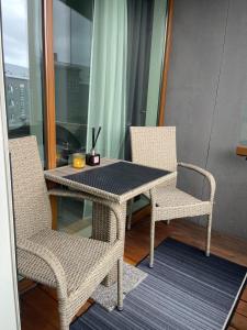 a table with two chairs and a table with a candle at Cozy Central Reykjavik in Reykjavík