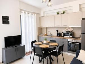 a kitchen with a table and chairs in a room at Aelia Blu 1 in Ofrínion