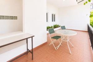 a room with a table and two chairs in a room at Urbanview Hotel RDN Oasis Cisarua by RedDoorz in Brujul