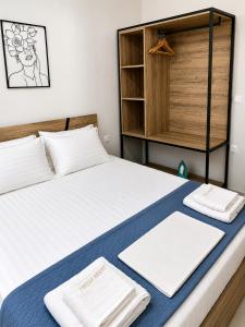 a bedroom with a bed with towels on it at Aelia Blu 1 in Ofrínion