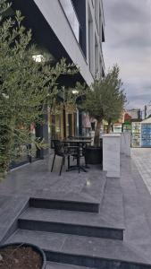 a courtyard with a bench and trees and a building at Wezen in Vama Veche