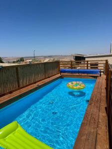 a pool with a slide and a pizza in it at sunrise valley - זריחת העמק in Yavneʼel