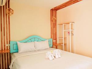 a bedroom with a bed with towels on it at Castaway's hua hin in Hua Hin +24 photos