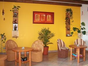 a yellow room with two tables and chairs at Spacious holiday home in Przesieka with sauna in Przesieka