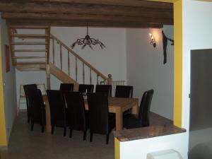 a dining room with a table and chairs and a staircase at Spacious holiday home in Przesieka with sauna in Przesieka