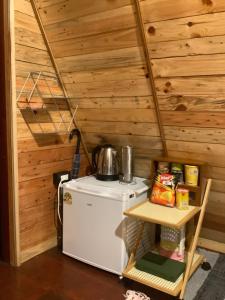 a kitchen with a small refrigerator and a stove at 385 Homestay & Lake camp in Ban Khai Nao (1)