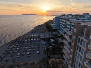 an aerial view of a beach with a sunset at Oasis Apart-Hotel Residence Vlore in Vlorë