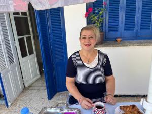 a woman standing in front of a table at Maison D Hotes Agama in Tizi Ouzou +19 photos