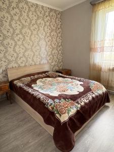 a bedroom with a bed with a quilt on it at fam rest in Garni +3 photos