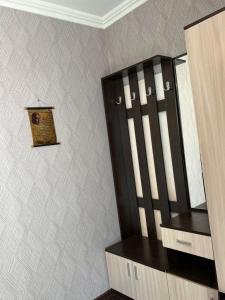 a mirror on a wall next to a wooden cabinet at fam rest in Garni